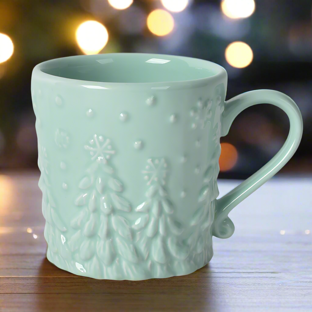 Frosty Forest mint mug on table near Christmas lights