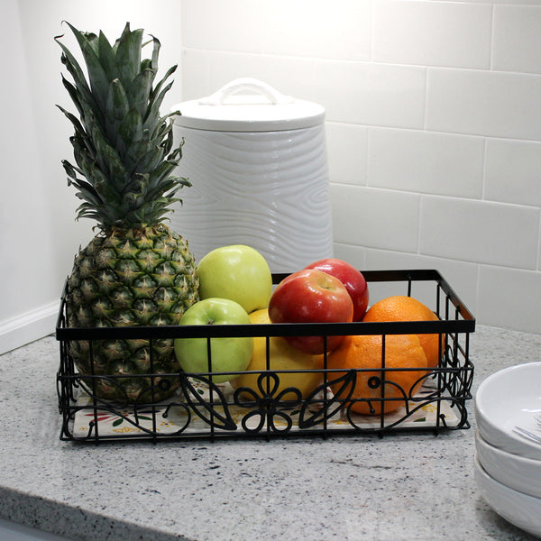 Temp-tations Metal Serving & Organizing Basket with Stoneware Trivet, filled with fresh fruit on kitchen counter